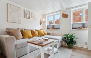a living room with a couch and a table at Pet Friendly Home In Rnne With Kitchen in Rønne