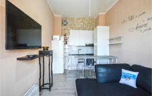 a living room with a couch and a kitchen at Stunning Apartment In Varazze With Wifi in Varazze