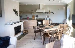 a kitchen with a table and chairs and a fireplace at 3 Bedroom Gorgeous Home In Ullared in Ullared