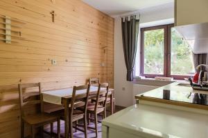 a kitchen with a table and chairs in a room at Honey Inn in Kamianna