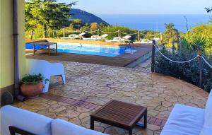 a patio with a pool and a table and chairs at 4 Bedroom Awesome Home In Caronia in Caronia