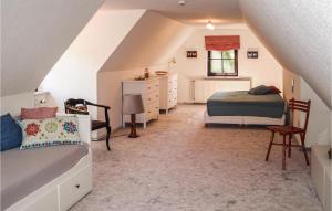 a attic bedroom with a bed and a dresser at 2 Bedroom Beautiful Home In Burg Stargard in Burg Stargard