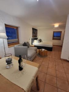 a living room with a couch and a table with wine glasses at Hotel - Landgasthof Post in Bichlbach