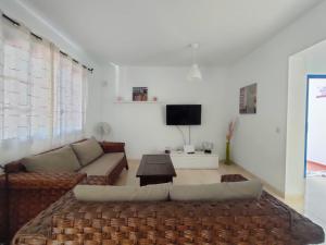 a living room with a couch and a tv at Villa Rubicón Costa in Playa Blanca