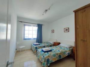 Łóżko lub łóżka w pokoju w obiekcie Villa Rubicón Costa