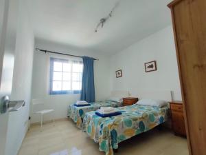 Łóżko lub łóżka w pokoju w obiekcie Villa Rubicón Costa