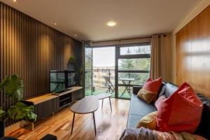 a living room with a couch and a television at Durham City Luxury Apartment in Durham