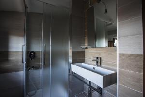 a bathroom with a sink and a shower at Antico Borgo B&B Seggiano in Seggiano