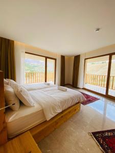 a bedroom with a large bed with a large window at Askireg Hotel 