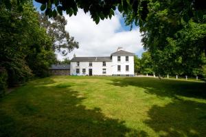 Kilpatrick Glebe في Crossabeg: منزل أبيض كبير مع ساحة كبيرة