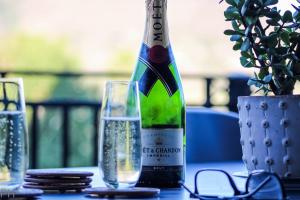 a bottle of wine sitting on a table with a glass at The Red Door in Clarens