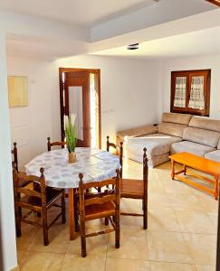 a living room with a table and a couch at CASA COTIELLA RAÑIN in Rañín