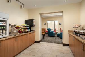 a kitchen with a waiting room with chairs at TownePlace Suites by Marriott Lexington Park Patuxent River Naval Air Station in Lexington Park