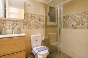 a bathroom with a toilet and a glass shower at Relaxing studio in Athens city center in Athens