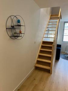 a wooden staircase in a room with a fan at Le Bubble - Centre Ville - La Bonne Marienne in Angers