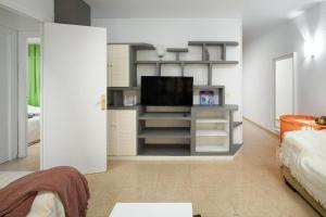 a living room with a flat screen tv on a shelf at Senda el Cantal 3habitaciones Beach in Cala del Moral