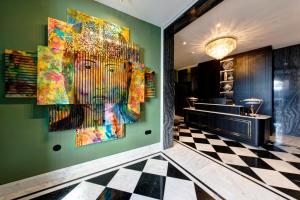 a room with paintings on the wall and a checkered floor at 1877 Estrela Palace in Aveiro +56 photos