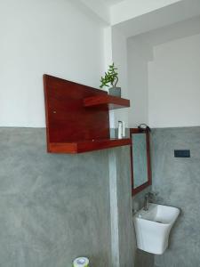 a bathroom with a toilet and a sink at KUMA'S HOTEL in Weligama