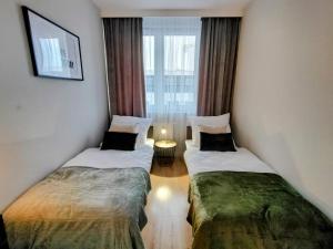 Säng eller sängar i ett rum på ApartamentySnu, Bulwary III Z parkingiem
