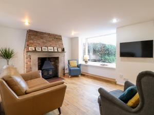 a living room with a couch and a fireplace at 35 Main Street in Nottingham