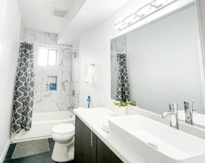 a bathroom with a sink and a toilet and a tub at 4BR L.A. Dream Home -CL1 in Los Angeles