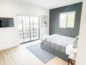 a bedroom with a bed and a large window at 4BR L.A. Dream Home -CL1 in Los Angeles