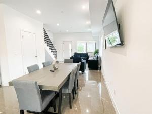 a dining room and living room with a table and chairs at 4BR L.A. Dream Home -CL1 in Los Angeles