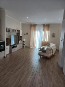 een grote woonkamer met een bank en een televisie bij la casa di Carla in Pescara