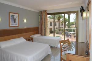 Postel nebo postele na pokoji v ubytování Hotel San Carlos + 37 fotografií