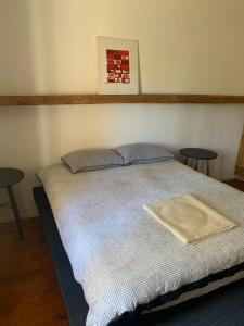 a bed in a room with two tables and a picture on the wall at Stormberg River Lodge in Elliot