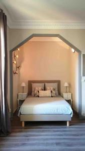 a bedroom with a bed with two nightstands and two lamps at Charming studio overlooking a beautiful garden in Nice