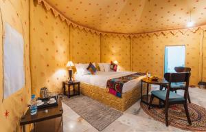 a bedroom with a bed in a tent at Sonal Desert Camp Jaisalmer in Jaisalmer