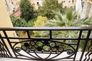 a rack of wine bottles on a balcony at Charming studio overlooking a beautiful garden in Nice