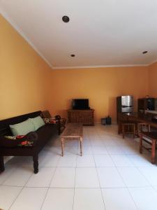 a living room with a couch and a table at Serasa Rumah Couple in Yogyakarta