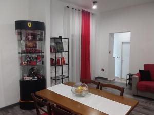 a living room with a table and a red couch at Il Cavallino, sul lago Ceresio in Brusimpiano