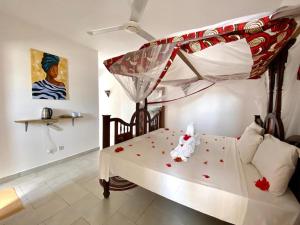 a bedroom with a bed with roses on it at Nungwi ocean view in Nungwi