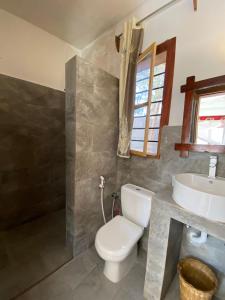 a bathroom with a toilet and a sink at Nungwi ocean view in Nungwi