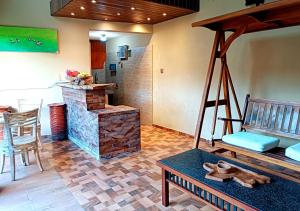 a living room with a stone fireplace and a table at Southern Bali Villa in Nusa Dua