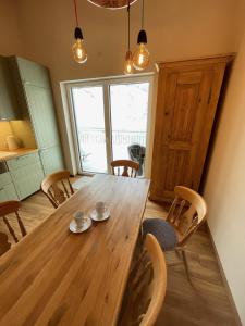 a dining room with a wooden table and chairs at Apart 7 Stuben in Stuben am Arlberg