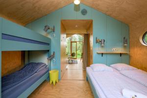 two beds in a room with blue walls at Stayokay Hostel Gorssel - Deventer in Gorssel