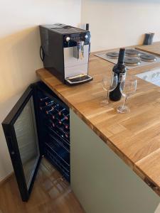 a counter with a microwave and two glasses of wine at Apart 7 Stuben in Stuben am Arlberg