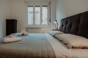 a bedroom with a large bed with two pillows on it at Elettra's studio x4 totally renovated in Trieste