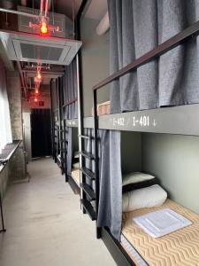 a row of bunk beds in a dorm room at Red Submarine in Kure