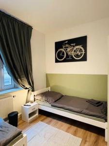 a bedroom with a bed and a picture of a motorcycle on the wall at Monteurswohnung an der Mulde in Döbeln