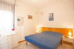 a bedroom with a blue bed and a window at Raffaella 2 in Campese