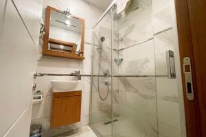 a bathroom with a sink and a glass shower at tidy 1BR apt near to nisantasi and Taksim #302 in Istanbul