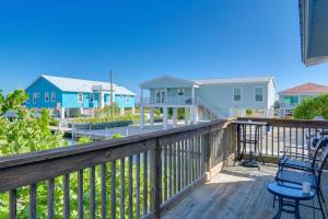 a deck with two chairs and some houses at Big Pine Key Home on Bogie Channel with Dock and Slip! in Big Pine Key