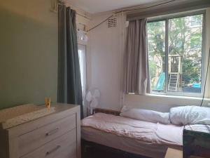 a small bedroom with a bed and a window at Appartement met 2 slaapkamers en tuin in Amsterdam in Amsterdam