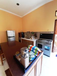 a kitchen with a counter and a stove top oven at Serasa Rumah Couple in Yogyakarta