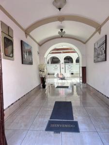 a large hallway with a blue rug on the floor at VIRREYES HOTEL in Potosí